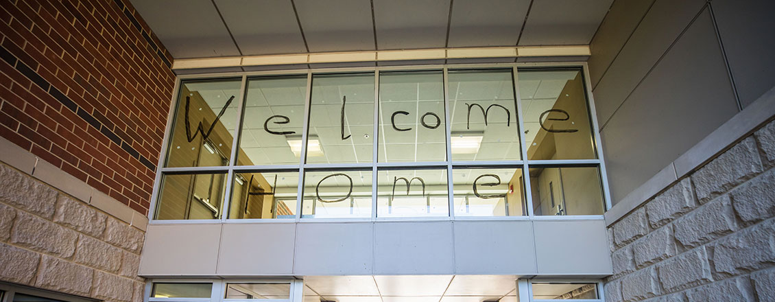 welcome home painted on window of dorm
