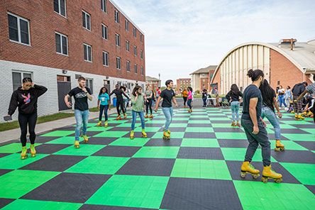 students roller skating in parking lot behind zimbar