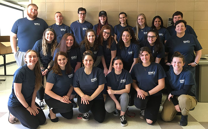 A large group of Sociology, Social Work and Criminal Justice Club students similes at the camera.