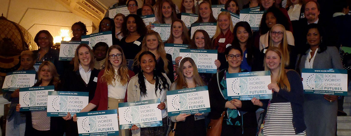 Students at Social Work Legislative Advocacy Day holding signs reading Social Workers change Futures