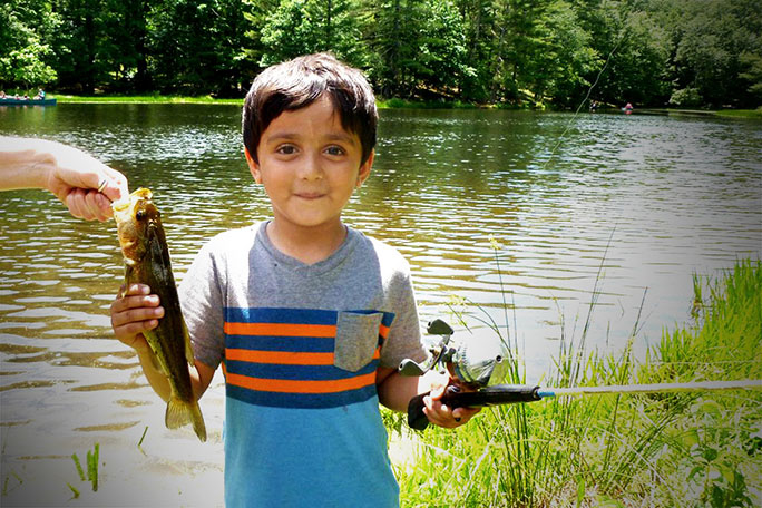 small boy holding a fish