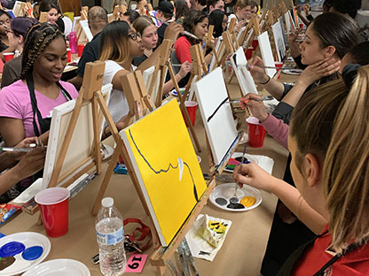 a group of students painting