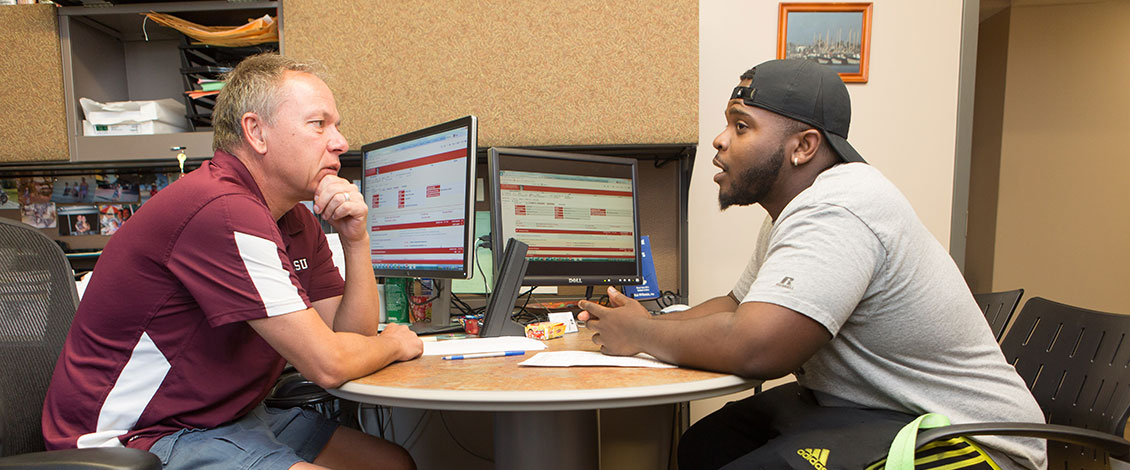A student talking with a faculty member during an advising session
