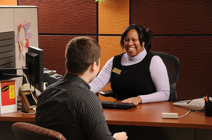 An enrollment counselor assisting a student