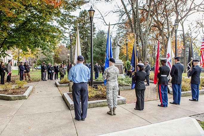 People holding military flags celebrating Veterans Day