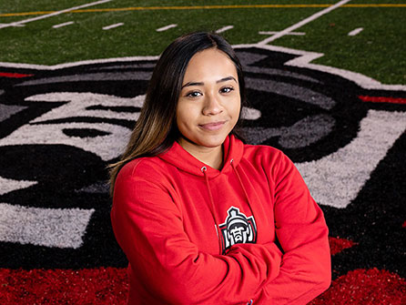 A female student standing on a football field