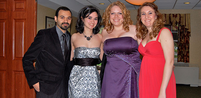 Students in formal dress attending a performance