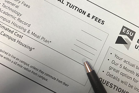 A pencil resting on a form reading Tuition and Fees