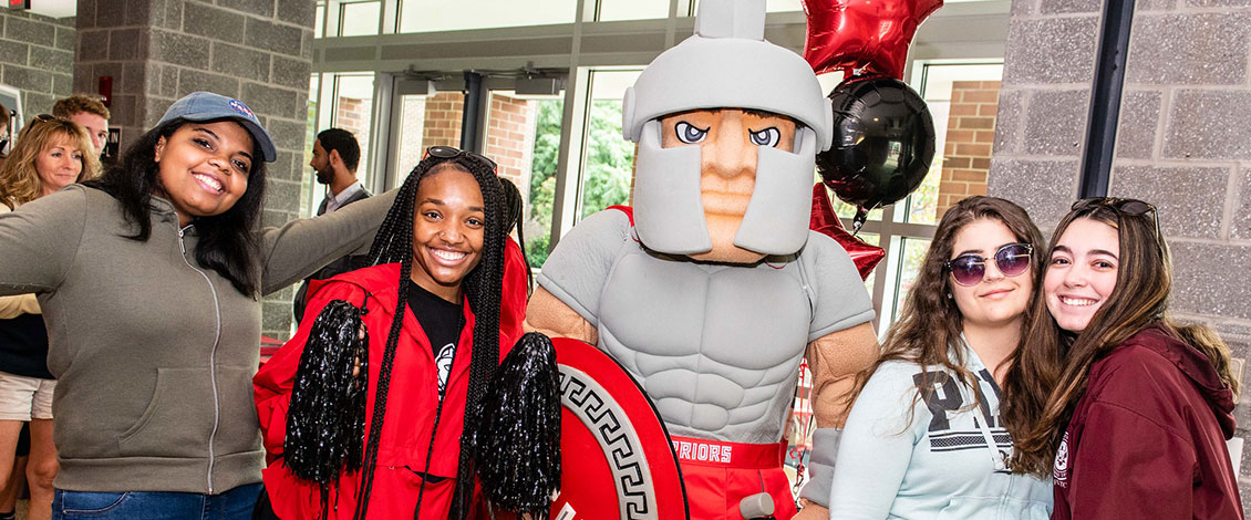 Student at open house with Warrior mascot