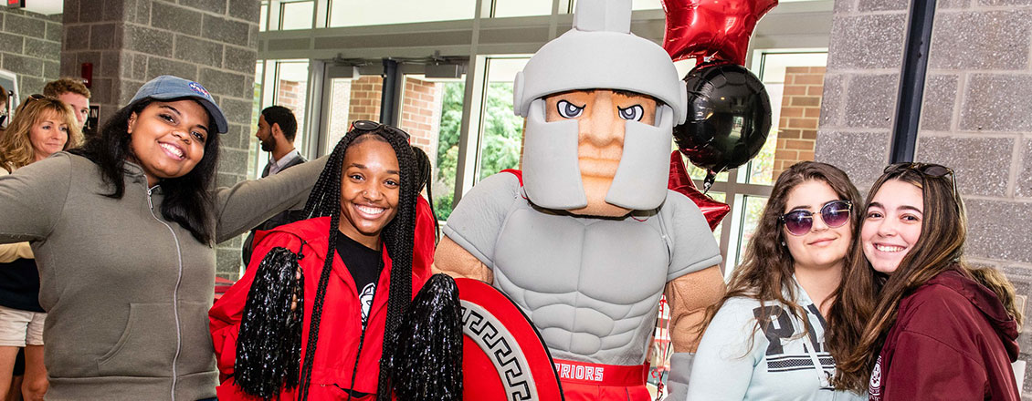 Student at open house with Warrior mascot